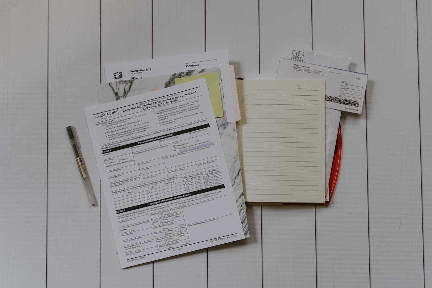 Insurance and tax paperwork organized on a desk