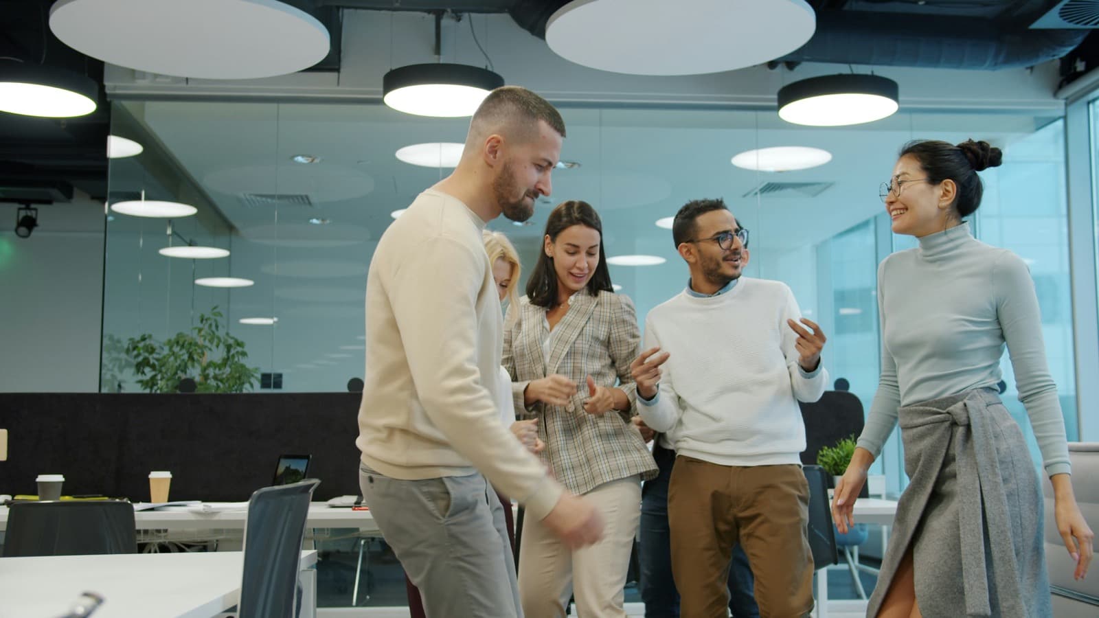 A happy agency team celebrating together in a modern office